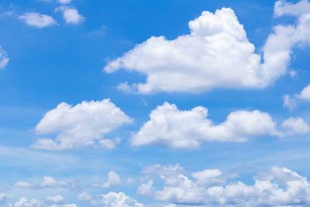 Blue sky background with white clouds, rain clouds on sunny summer or spring day.の写真素材