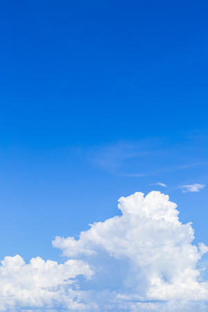 Blue sky background with white clouds, rain clouds on sunny summer or spring day.の写真素材