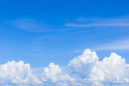 Blue sky background with white clouds, rain clouds on sunny summer or spring day.の写真素材