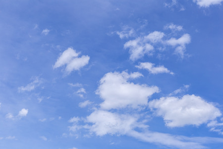 Blue sky background with white clouds, rain clouds on sunny summer or spring day.の写真素材