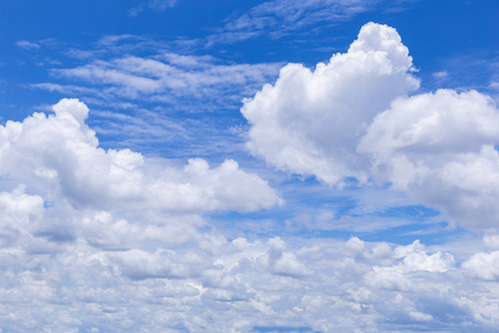 Blue sky background with white clouds, rain clouds on sunny summer or spring day.の写真素材