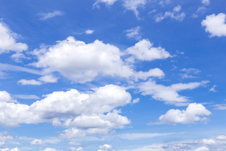 Blue sky background with white clouds, rain clouds on sunny summer or spring day.の写真素材
