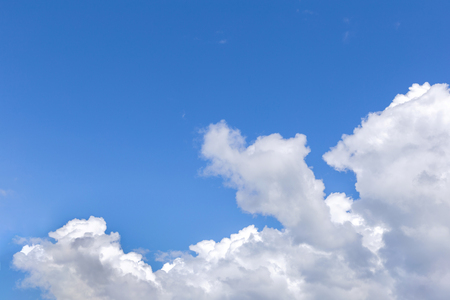 Blue sky background with white clouds, rain clouds on sunny summer or spring day.の写真素材