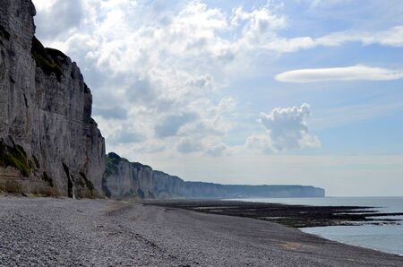 A solitary beach under the cliffs in the last lights of the dayの写真素材