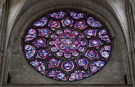 The multicolored rose window illuminates the interior of the church
