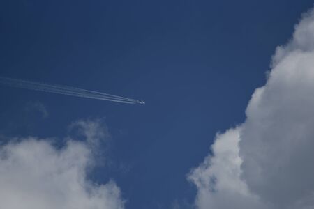 An airliner darts high in the sky above the valley