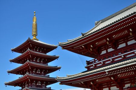 The roof of temples seem to touch in the blue sky