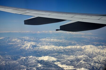 Flying
at high altitude the earth offers a fantastic scenery of snow-covered mountainsの写真素材