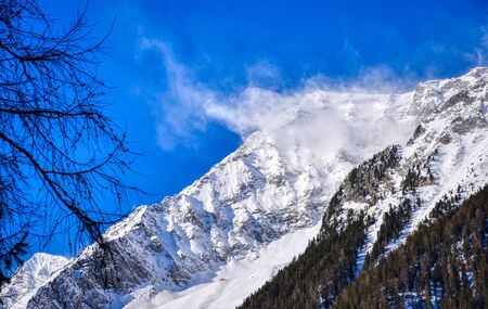The wind raises snow clouds on the peaks of the Anterselva valley
