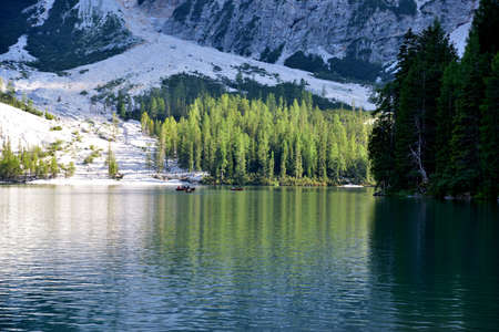 The upper part of Lake Braies. Some boats in a corner of the lake under the Croda del Becco