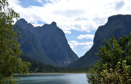 Overlooking the waters of Lake Dobbiaco, the characteristic Mount Nasswand of 2251 meters highの写真素材