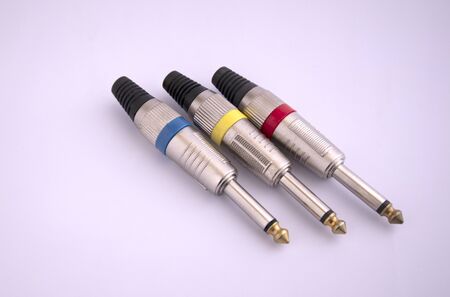 Three colors of audio plug and microphone connector isolated on white backgroundの写真素材