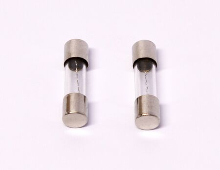 safety electrical fuse in glass capsule shape, isolated on white backgroundの写真素材