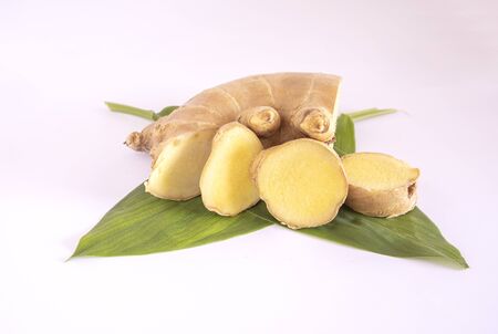 Sliced ginger root is easier to store than whole roots and have more preserved flavor on white backgroundの写真素材