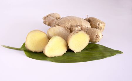 Dried Asian Ginger root and slices with leaves isolated on white backgroundの写真素材