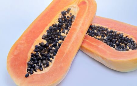 Sliced sweet half papaya isolated on white backgroundの写真素材