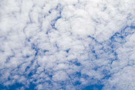 Beautiful bright blue sky with white fluffy clouds on a clear sunny.の写真素材