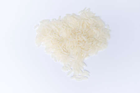 Top view. Close up jasmine rice heap isolated on white background. Flat lay