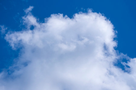 The softness of the fluffy white clouds in the blue sky is super romantic same as in heavenの写真素材