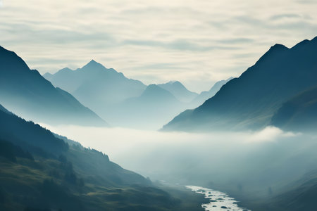Foggy mountain landscape with a river flowing through the valley.の素材