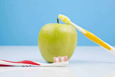 green apple and toothbrushesの写真素材