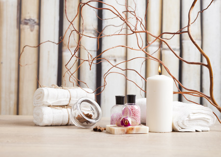 Spa and wellness setting with flowers, candles and toweの写真素材