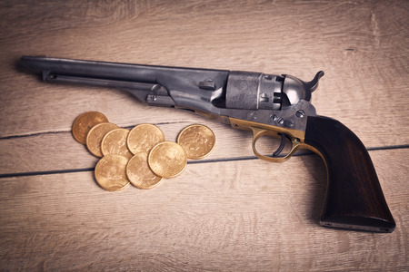 old revorver and gold coins
