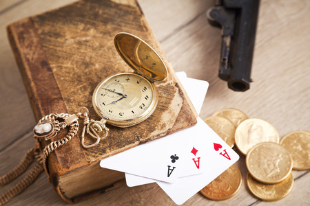 gambling and crime concept with gun, cards and golden coinsの写真素材