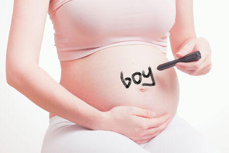 Cute pregnant mother expecting a baby boyの写真素材