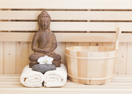 wellness and relaxation items in sauna with buddha statue