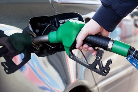 Male hand holding gasoline pump