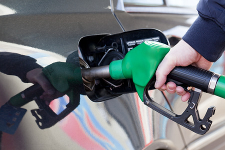 Male hand holding gasoline pumpの写真素材
