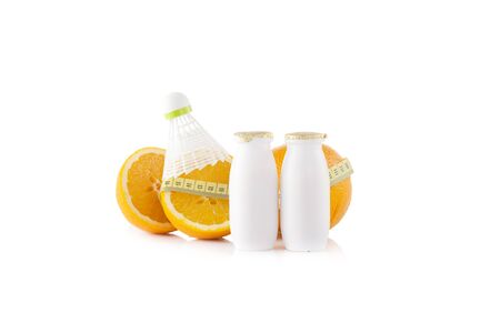 Protein drinks with badminton shuttlecock on the two halves of orangeの写真素材