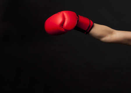 Punching with red boxing glove, fight conceptの写真素材