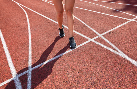 Sportswoman running on a racetrack