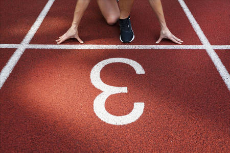 Female Hands on starting line waiting for start in running track, workout sessionの写真素材