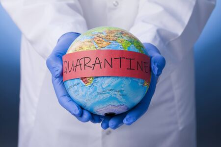 Medical officer holding earth with quarantineの写真素材