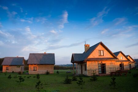 Group of wooden houses in a red light of sunrise