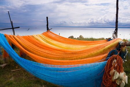 Colorful fishing nets drying oa a sea shore.の写真素材