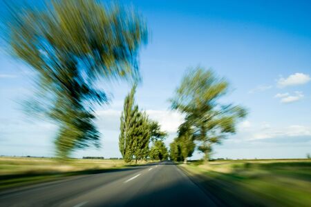 Road and green trees with motion blur.の写真素材