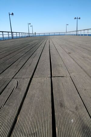 Wooden pier with lamps over a seaの写真素材