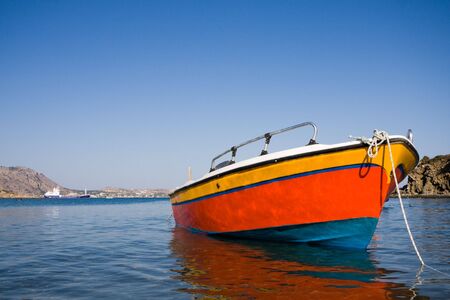 Colourful small fishing boat on a seaの写真素材