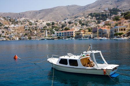 Small yacht and houses on symi islandの写真素材