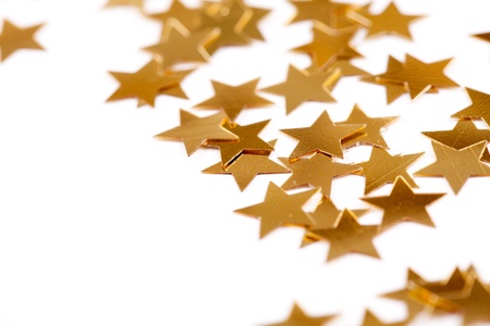 Christmas decoration of golden confetti stars against white background with nice bokeh