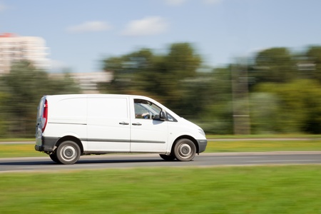 White van on road in intentional motion blur