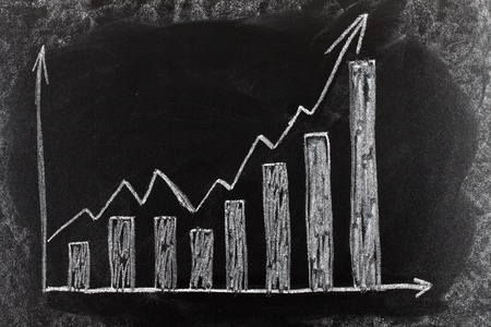 Business chart on blackboard showing increase in salesの写真素材
