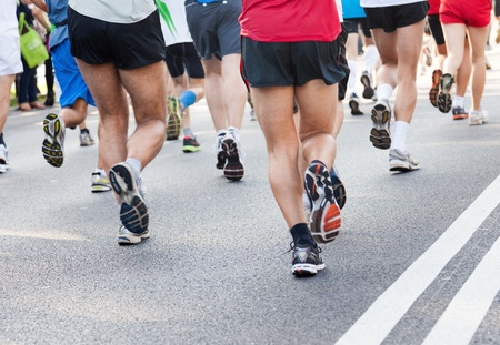 People running fast in a city marathon on streetの写真素材