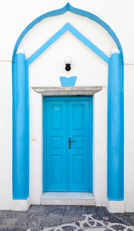 Traditional greek blue doors in white buildingの写真素材