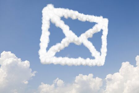 Email and mail communication concept symbol in clouds on blue skyの写真素材