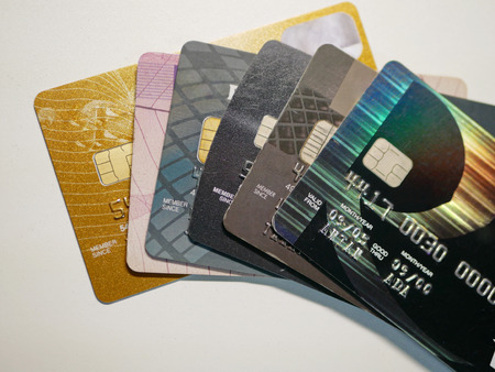Selective foucs of mixed debit and credit cards on a white background